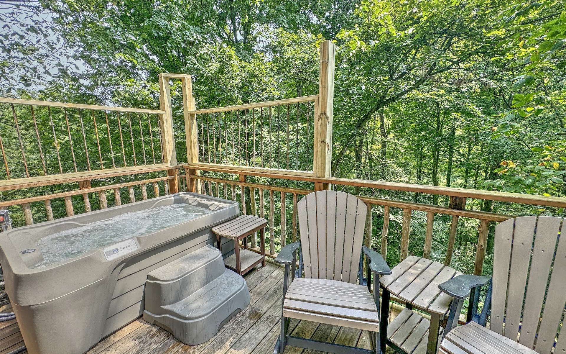 Pine Cove treehouse with private hot tub on a wooded deck