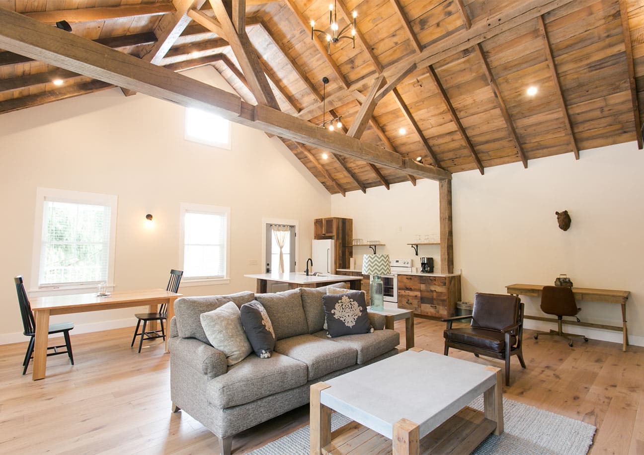 Pine Cove Barn Suite interior with fireplace and king bed